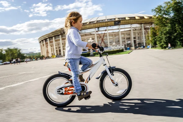 Nettes kleines Mädchen fährt schnell mit dem Fahrrad — Stockfoto