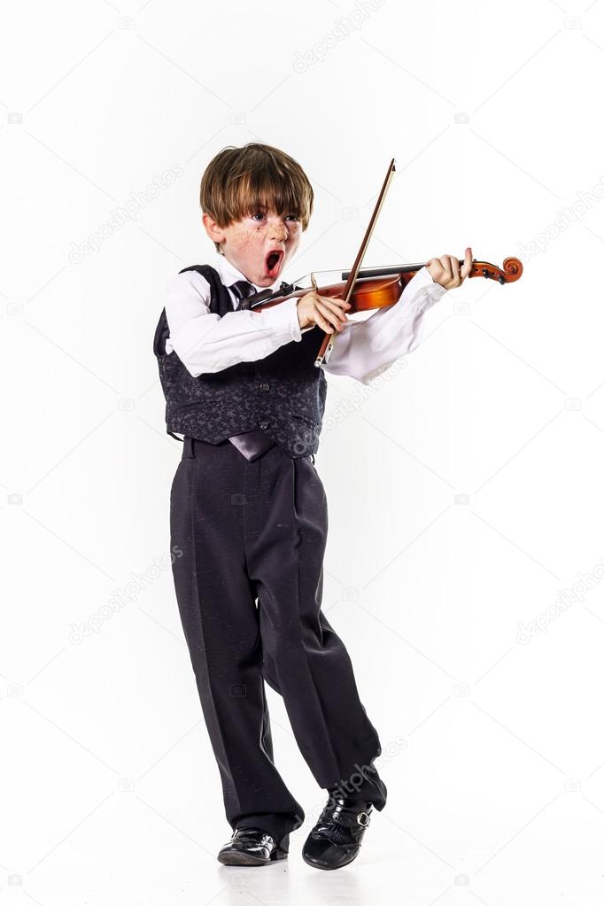 Red-haired preschooler boy with violin