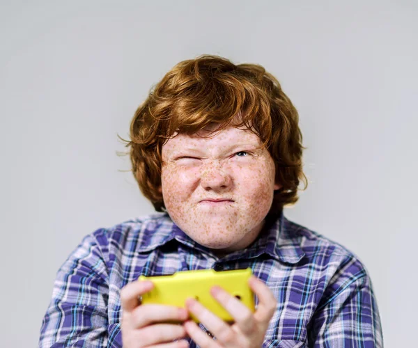 Comic freckled red-haired boy with mobile phone — Stock Photo, Image