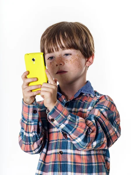 Red-haired funny boy with mobile phone — Stockfoto