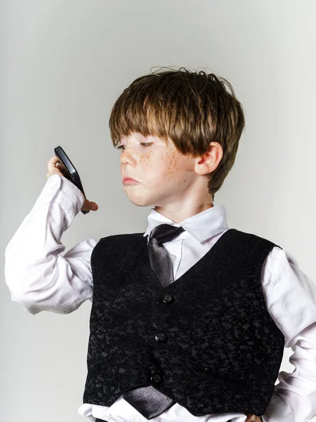 Emotional red-haired boy with mobile phone — Stock Photo, Image