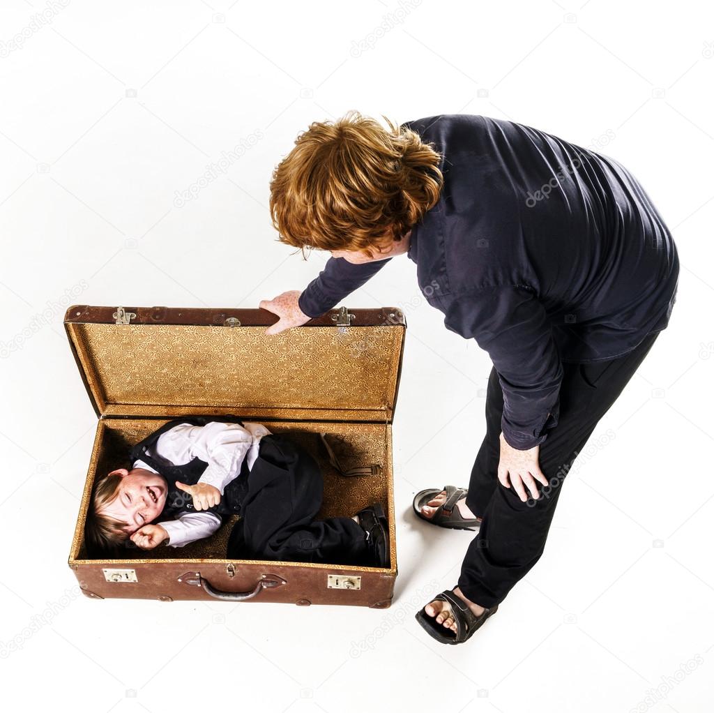 Two brothers playing with retro suitcase