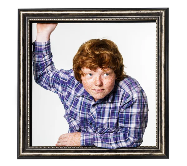 Red-haired boy posing with picture frame — Stock Photo, Image