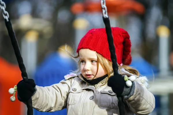 Cute little girl swinging on seesaw — Stock Photo, Image