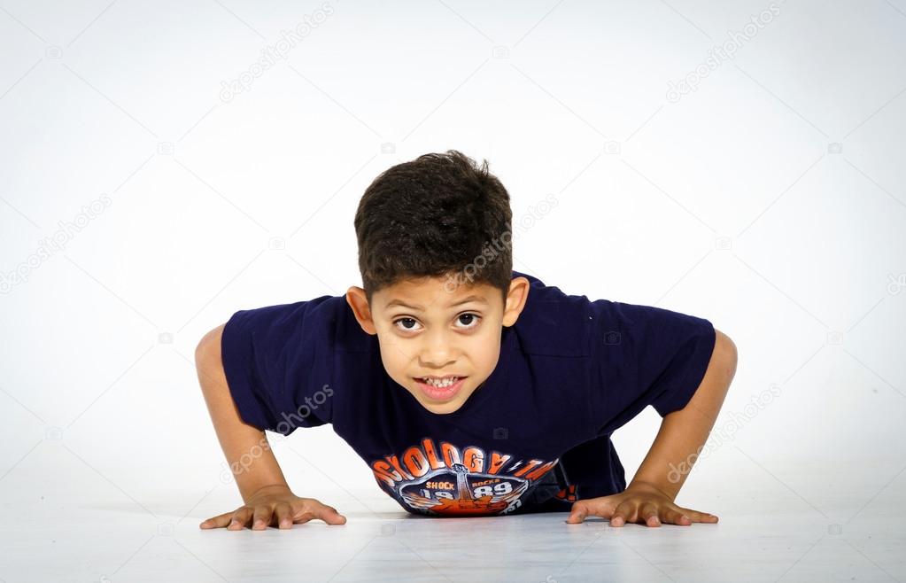 Young active afro-american boy doing gymnastics 
