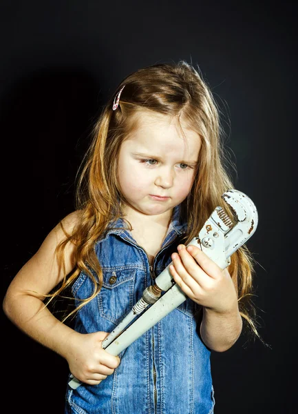 Cute little girl with gas spanner in her hands — Stock Photo, Image