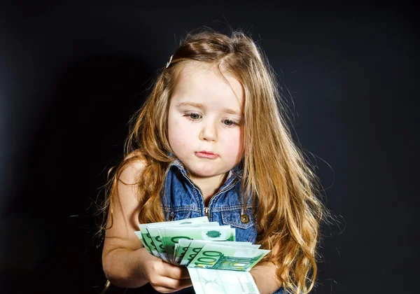 Cute little girl with money euro in her hand. — Stock Photo, Image