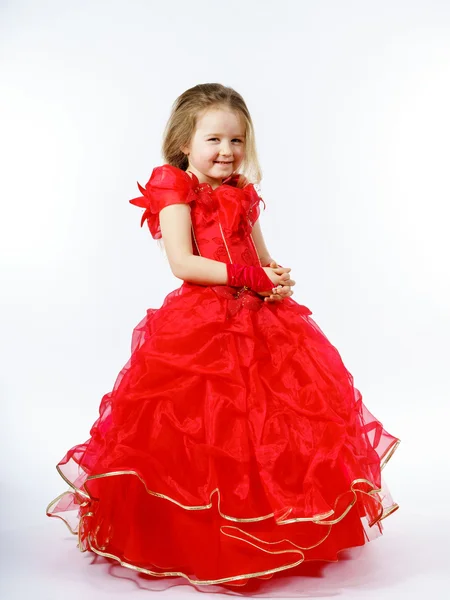 Cute little princess dressed in red dancing. Isolated on white b — Stock Photo, Image