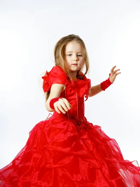 Cute little princess dressed in red dancing. Isolated on white b — Stock Photo, Image