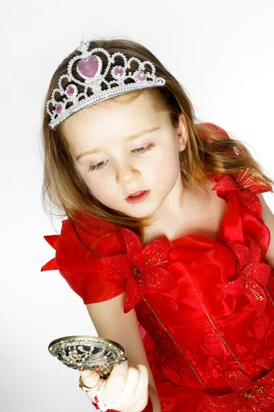 Cute little princess dressed in red isolated on white background Royalty Free Stock Images