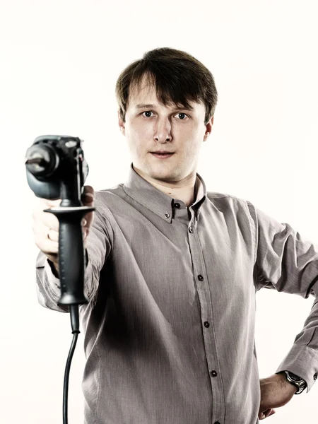 Mladý muž s elektrická vrtačka izolovaných na bílém — Stock fotografie
