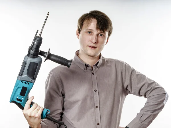 Young man with electric drilling machine isolated on white — Stock Photo, Image