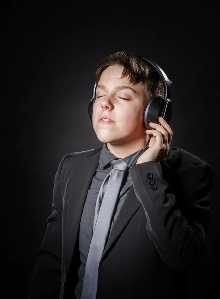 Teenage boy listening music in headphones — Stock Photo, Image