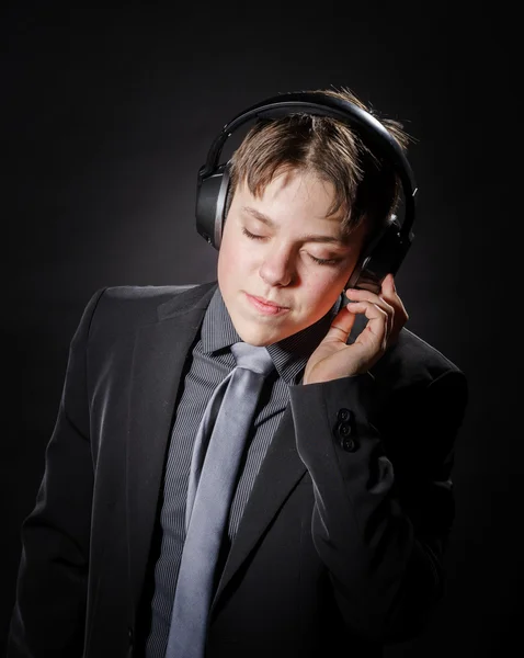 Teenage boy listening music in headphones — Stock Photo, Image