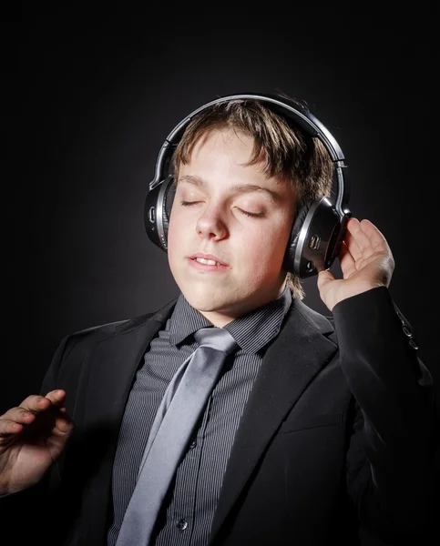 Teenage boy listening music in headphones — Stock Photo, Image