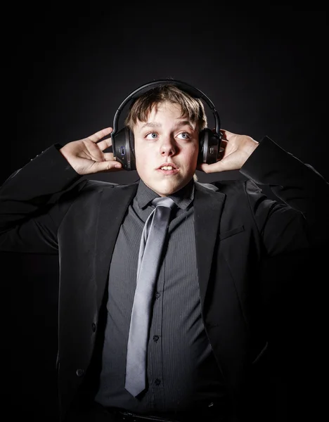 Teenage boy listening music in headphones — Stock Photo, Image