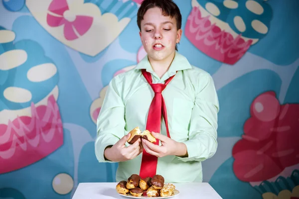 Divertente ragazzo mangiare dolci torte, affamati e caramelle uomo — Foto Stock