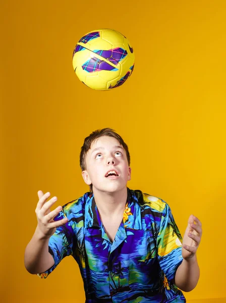 Affective teenage boy playing with ball — Stock Photo, Image