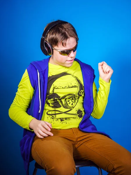 Affective teenage boy listening music in headphones — Stock Photo, Image