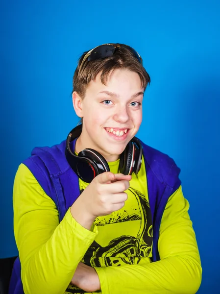 Affective teenage boy listening music in headphones — Stock Photo, Image