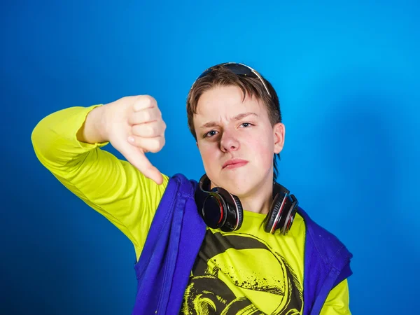 Affective teenage boy listening music in headphones — Stock Photo, Image