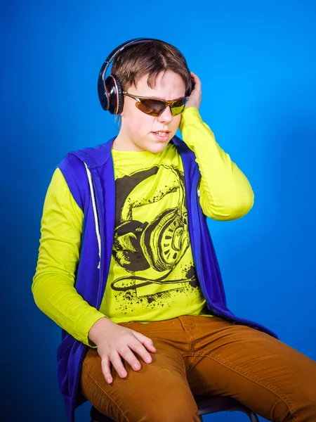 Affective teenage boy listening music in headphones — Stock Photo, Image