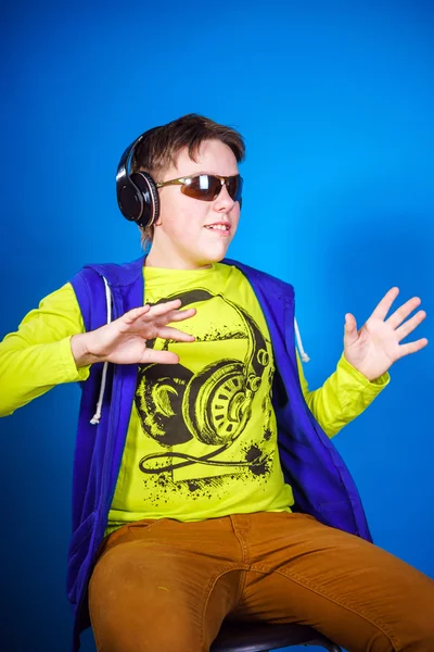 Affective teenage boy listening music in headphones — Stock Photo, Image