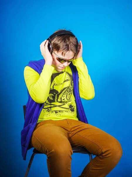 Affective teenage boy listening music in headphones — Stock Photo, Image