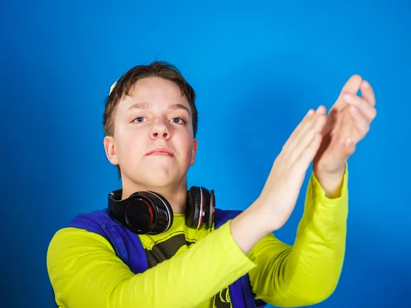 Affective teenage boy listening music in headphones — Stock Photo, Image