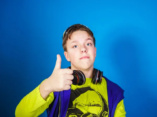 Affective teenage boy listening music in headphones — Stock Photo, Image