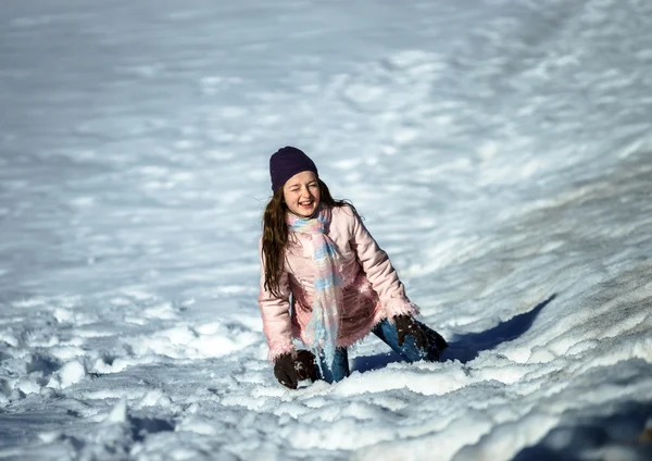 Söta tonårsflicka spelar i vit snö — Stockfoto