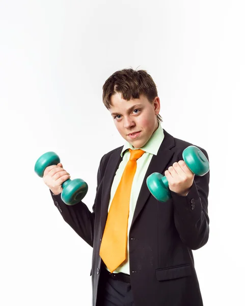 Teenage boy dressed in office suit doing sport exercises — Stock Photo, Image