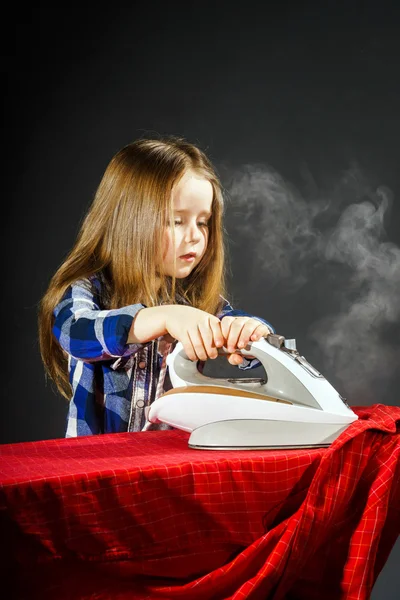 Cute little girl helping your mother by ironing clothes, contras — Stock Photo, Image