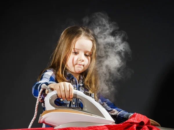 Cute little girl helping your mother by ironing clothes, contras — Stock Photo, Image