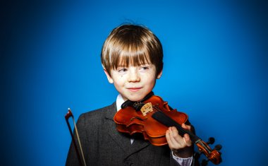 Red-haired preschooler boy with violin, music concept clipart