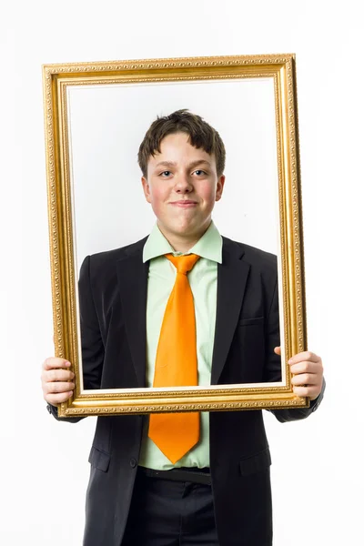 Expressive teenage boy posing with picture frame — Stock Photo, Image