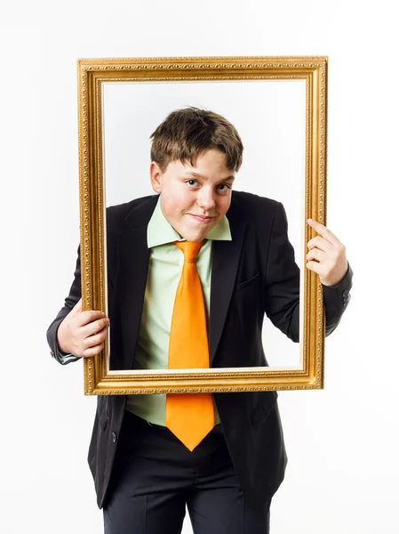 Expressive teenage boy posing with picture frame — Stock Photo, Image