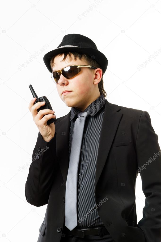 Teenage boy posing like a guardsman with radio transmitter