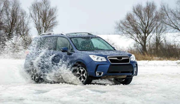 Powerful offroader car sliding by lake ice — Stock Photo, Image