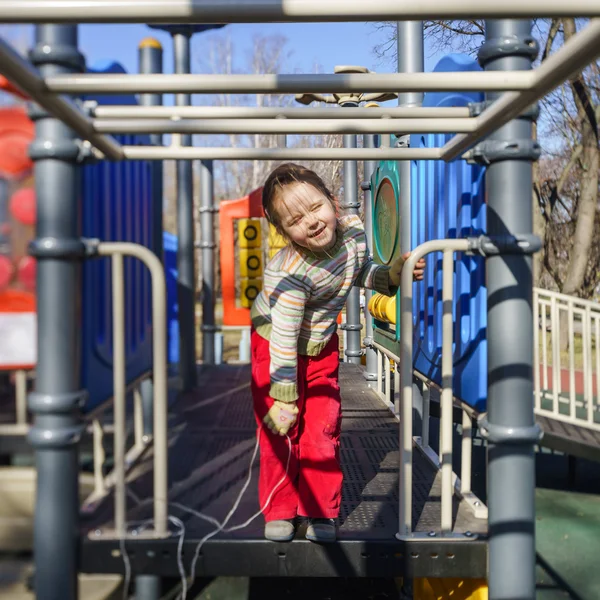Cute little girl playing on child playground — Stock Photo, Image