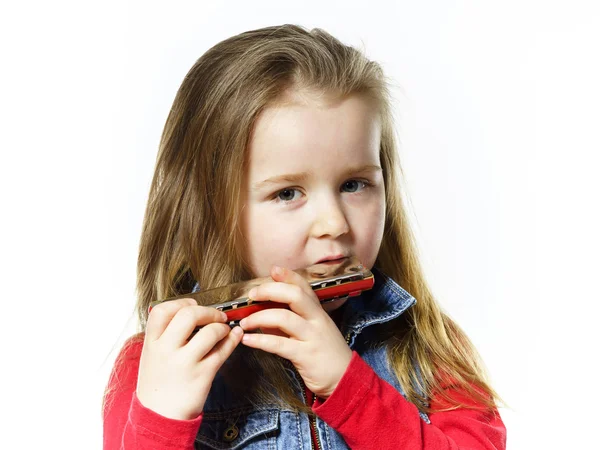 Cute little girl playing harmonica, music education concept — Stock Photo, Image