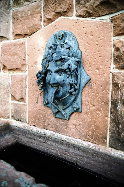 Funny bas-relief of Bacchus head as part of the fountain — Stock Photo, Image