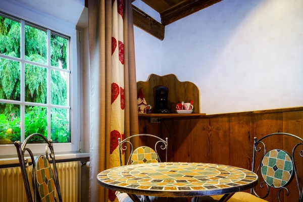 Drop-forged table with chairs in old-style room — Stock Photo, Image