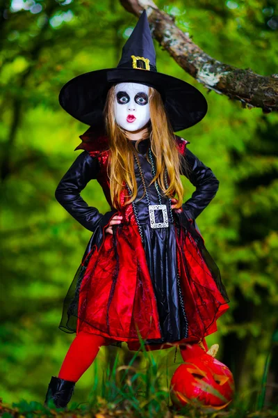 Niedliches Mädchen im Halloween-Kostüm im dunklen Wald — Stockfoto
