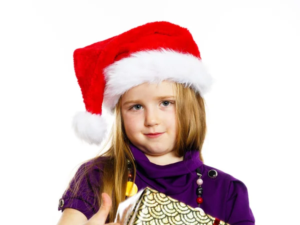 Cute little preschooler girl in red santa hat with gift box — Stockfoto