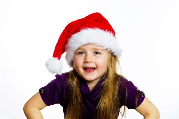 Cute little preschooler girl in red santa hat with gift box — Stock fotografie