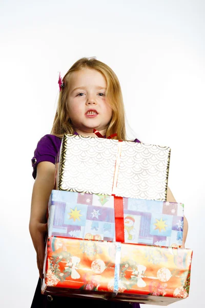 Cute little preschooler girl in red santa hat with gift box — Stok fotoğraf