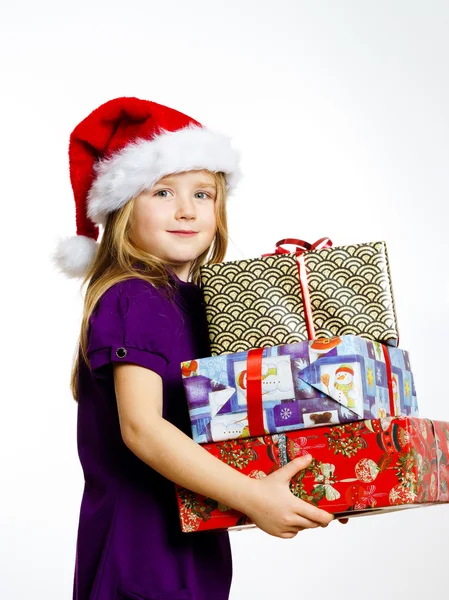 Cute little preschooler girl in red santa hat with gift box — Stock fotografie