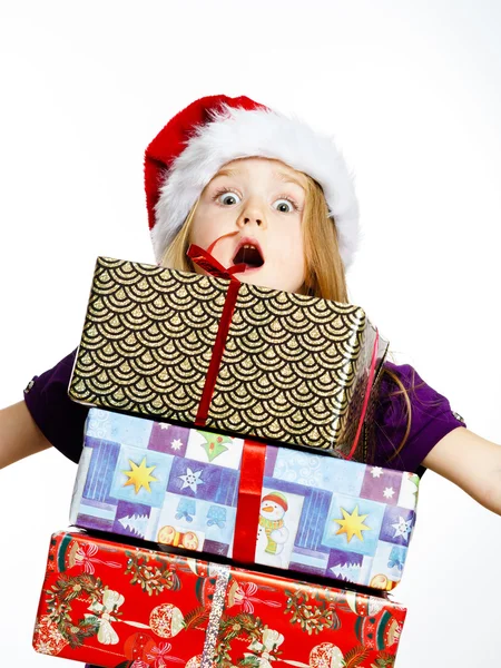 Cute little preschooler girl in red santa hat with gift box — Stok fotoğraf