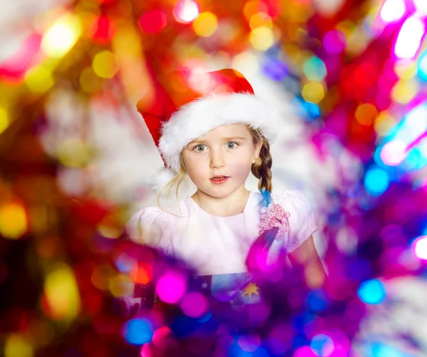 Pretty little girl dressed in santa red hat, new year portrait w — Stock Photo, Image